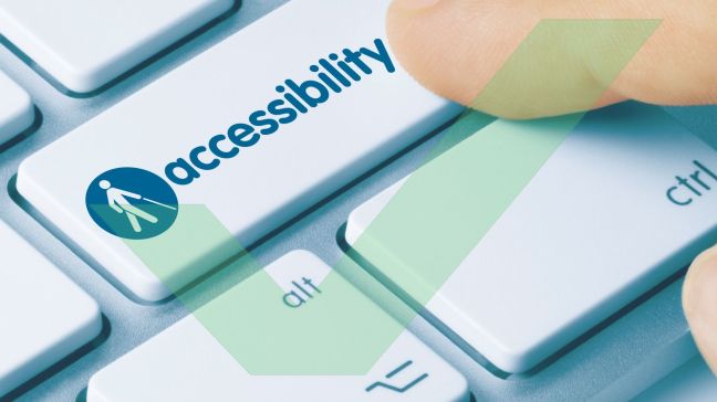 A close up of a keyboard, the enter key has the word accessibility on it and a finger is pressing the key with VAC Green tick